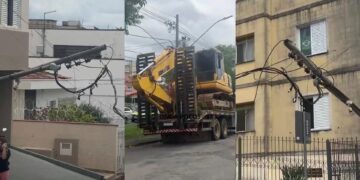 Caminhão com retroescavadeira enrosca em fiação e derruba poste em Poços de Caldas